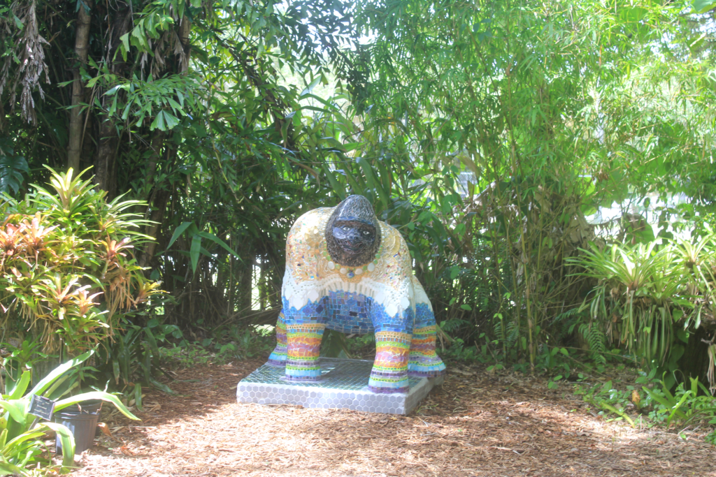 Mosaic gorilla statue in the rainforest garden.